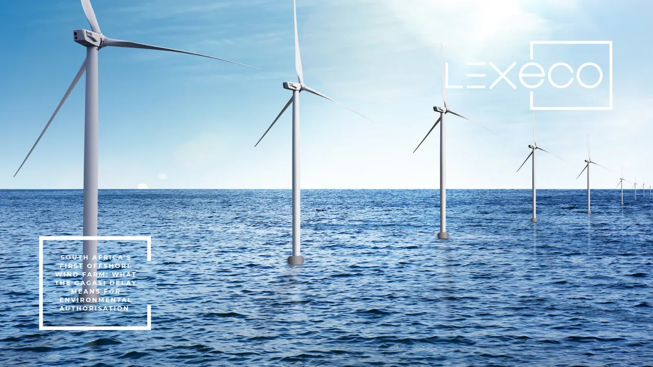Offshore wind turbines in a row at sea under a blue sky